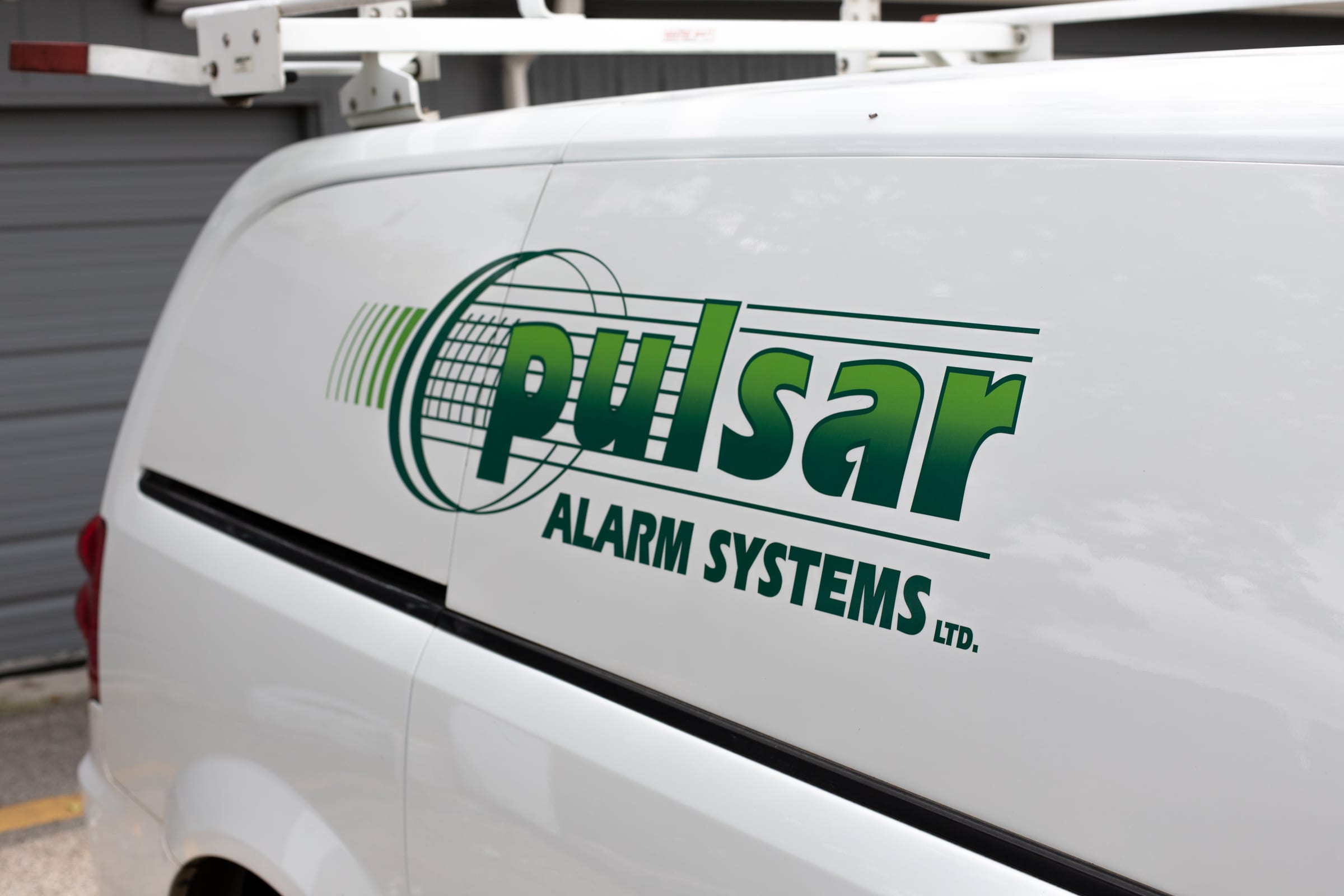 The Pulsar Alarm Systems logo on a service van